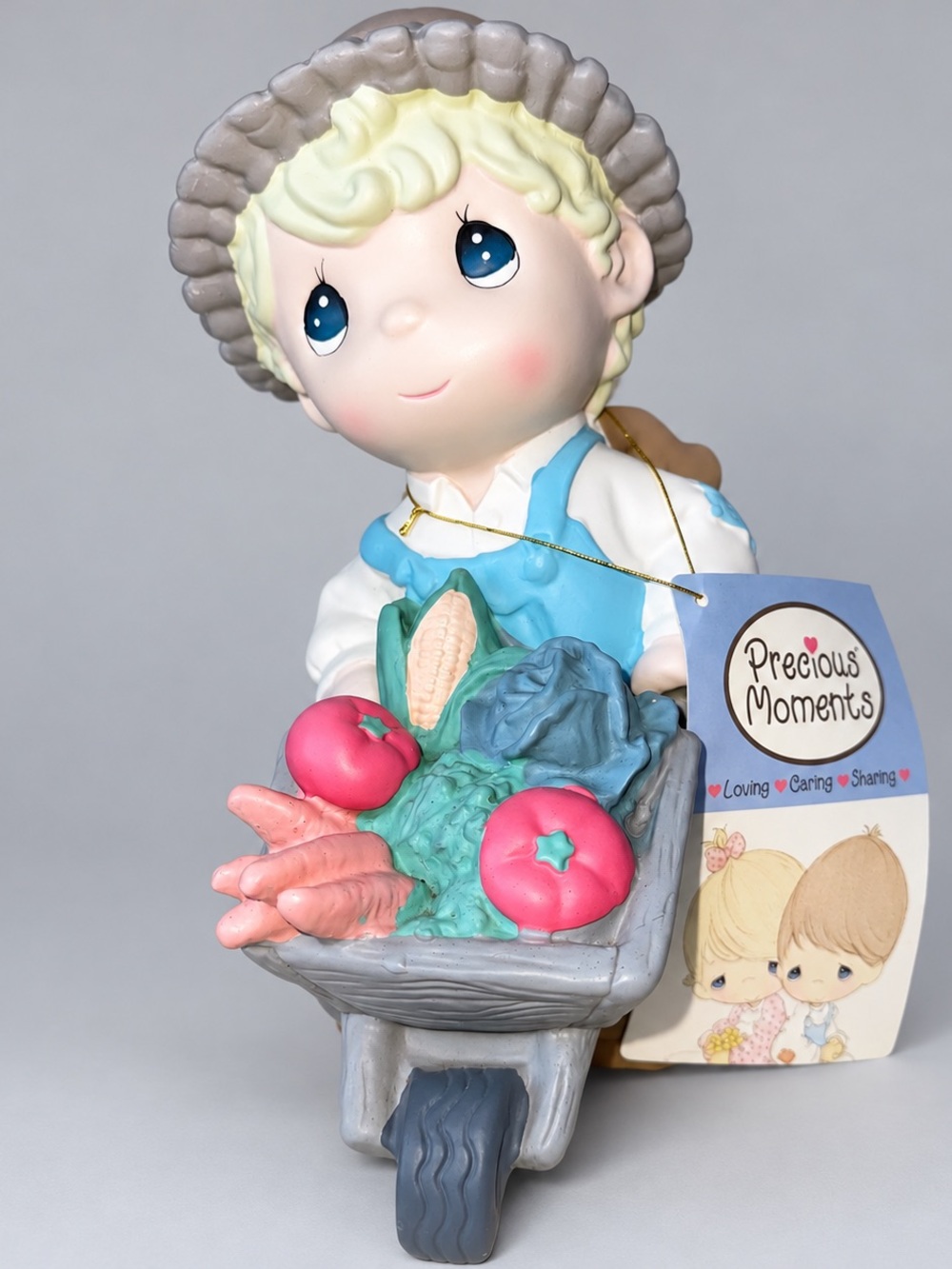 Precious Moments Figurine with Blue Overalls and Gray Wheelbarrow